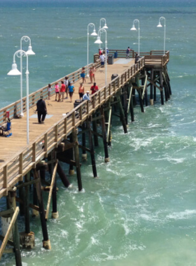 This image shows the Daytona Beach Boardwalk and Pier, with colorful rides and shops lining the walkway. Visitors enjoy carnival games, ocean views, and a vibrant seaside experience.
