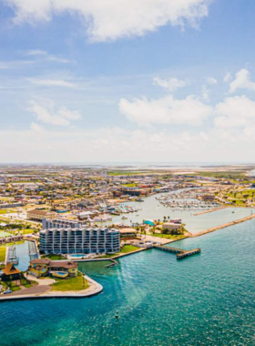 This image shows Port Aransas, a charming coastal town known for its pristine beaches, local seafood restaurants, and vibrant art scene. It’s a popular spot for fishing and enjoying beachside activities.