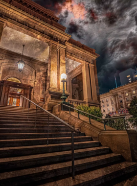  This image shows a group of visitors on a walking ghost tour in Corpus Christi at night. The tour explores the city’s haunted history, taking visitors through eerie locations and sharing spooky local legends.