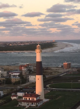 This image shows the view from the top of the Absecon Lighthouse, with visitors enjoying panoramic views of the Atlantic City skyline, beach, and surrounding areas from the 171-foot tall structure.