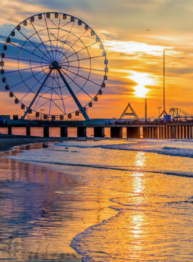 This image shows the Steel Pier amusement park in Atlantic City, with thrilling rides like a Ferris wheel and roller coasters, and visitors enjoying games and attractions along the boardwalk.