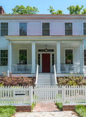 This image shows the historical Poplar Grove Plantation in Wilmington, with visitors touring the old manor house and exploring the farm and gardens, learning about agricultural life in the 19th century.