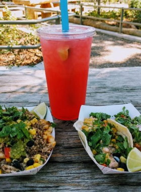 This image shows Mr. Nice Guys Food Truck parked at its location, with customers enjoying freshly made gourmet dishes in a lively outdoor setting.