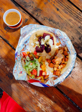 This image shows a variety of traditional Santa Fe dishes, including chile rellenos, tamales, and sopapillas, reflecting the city’s Southwestern culinary flavors.