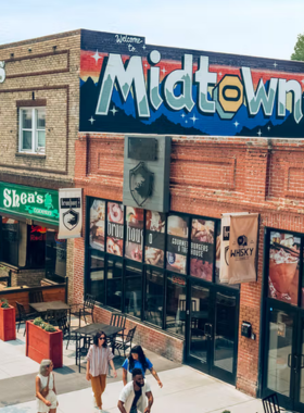 This image shows a street scene in Midtown Reno, featuring colorful murals, unique boutiques, and cozy cafes. It captures the area's artistic atmosphere, offering a mix of trendy shopping, local art, and vibrant street life, making it a perfect spot for visitors to explore.

