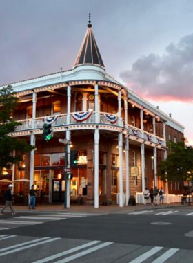 This image shows a lively street in Flagstaff’s Historic Downtown, lined with charming historic buildings, local shops, and colorful banners.