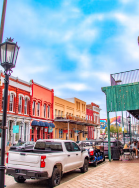  This image shows visitors strolling through The Strand district, admiring the colorful historic buildings and browsing through charming antique shops and boutique stores along the street.