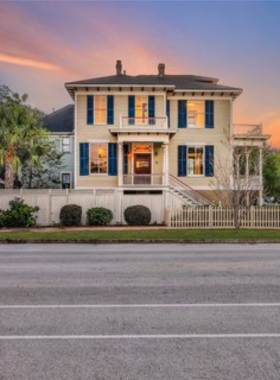 This image shows visitors walking through the East End Historical District, admiring the beautifully restored Victorian homes and historic landmarks in the charming neighborhood.