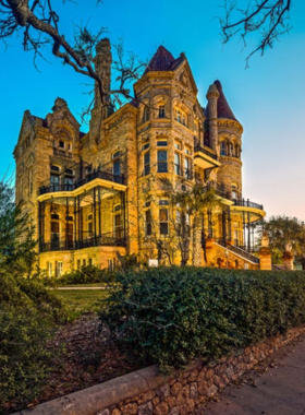 This image shows the grand exterior of Bishop’s Palace, with its impressive Victorian Gothic architecture, intricate stone carvings, and beautifully landscaped grounds in the heart of Galveston.