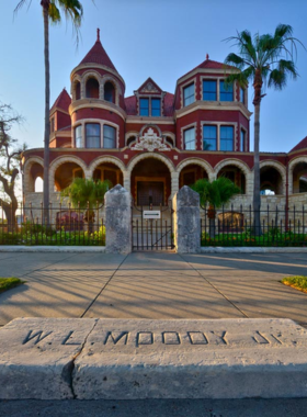  This image shows the elegant interior of the Moody Mansion, featuring luxurious furniture, grand chandeliers, and stunning woodwork that reflects the opulence of its historical past.
