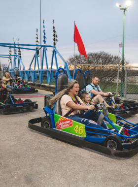 This image shows go-kart racing at Celebration Station, an entertainment venue in Greensboro offering thrilling activities such as bumper boats, arcade games, and mini-golf for family fun.