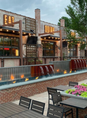 This image shows a modern, stylish bowling alley at Bourbon Bowl in Greensboro, where guests enjoy bowling, craft cocktails, and an upscale entertainment experience.