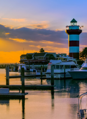 This image shows the top view from the Harbour Town Lighthouse, featuring panoramic scenes of the marina and coastline.