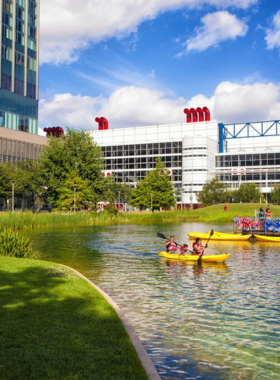  This image shows people enjoying outdoor activities at Discovery Green, a lively urban park in downtown Houston. It features grassy lawns, water features, and a variety of events like concerts, yoga sessions, and outdoor movie nights.