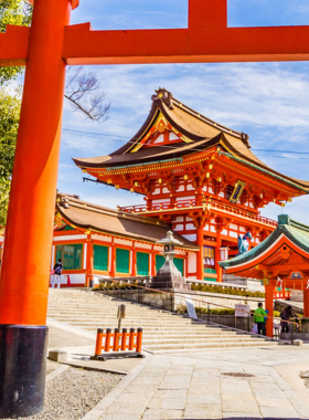 This image shows the iconic red Torii gates of Fushimi Inari Shrine, forming a winding path up Mount Inari. Visitors walk through these sacred gates, enjoying a spiritual journey surrounded by dense greenery and serene landscapes.
