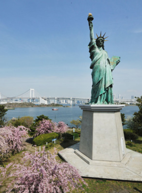 This image shows Odaiba's stunning waterfront, featuring the Rainbow Bridge and modern architecture. Visitors enjoy a peaceful promenade with views of the Tokyo skyline, blending urban design with natural beauty.
