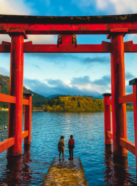 This image shows a scenic cruise on Lake Ashi, surrounded by Mount Fuji and lush landscapes. Visitors enjoy tranquil boat rides, capturing stunning views and experiencing the natural beauty of Hakone.