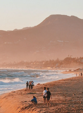 This image shows Zuma Beach’s pristine sands, clear waters, and peaceful atmosphere, perfect for family outings and beach activities.