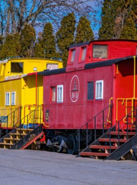 This image shows the iconic Red Caboose Motel, where visitors can stay inside restored train cars, offering a nostalgic and unique lodging experience in Lancaster County.