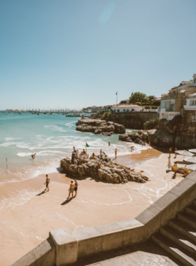 This image shows the beautiful Cascais Beach, with golden sands and clear blue waters, offering a relaxing seaside escape just outside Lisbon.