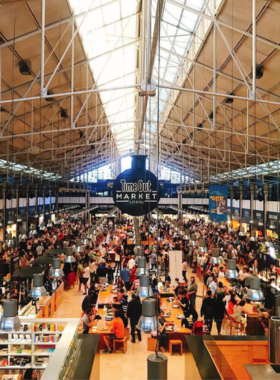 This image shows the bustling Mercado da Ribeira in Lisbon, with its wide variety of food stalls offering fresh seafood, traditional Portuguese dishes, and international cuisines.

