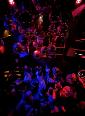 This image shows a traditional Fado music performance in one of Lisbon’s intimate Fado clubs, where soulful singing and guitar melodies fill the air.