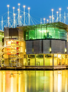  This image shows the Lisbon Oceanarium, one of the world’s largest indoor aquariums, with vibrant marine life including sharks and sea turtles swimming in the central tank.