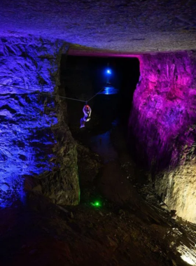  This image shows visitors zipping through the underground tunnels of the Louisville Mega Cavern, showcasing an exciting underground adventure with stunning cavern views.