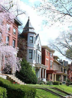 This image shows the beautiful Victorian-era architecture of Old Louisville, with historic mansions and lush green streets, showcasing one of the largest historic districts in the U.S.