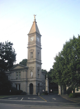  This image shows the serene Cave Hill Cemetery in Louisville, with beautifully landscaped gardens, towering monuments, and tranquil walking paths, offering a peaceful atmosphere.