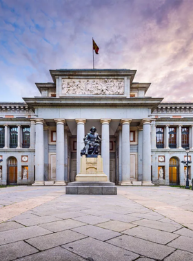  This image shows the exterior of the Prado Museum, a world-famous art museum in Madrid, housing masterpieces from artists like Velázquez, Goya, and Rembrandt, a must-visit for art lovers.