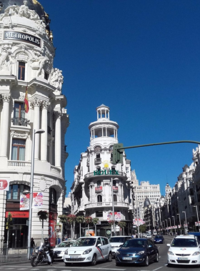 This image shows Gran Vía, a bustling avenue in Madrid known for its theatres, shopping centers, and iconic architecture, offering a vibrant atmosphere and the heart of the city’s culture.