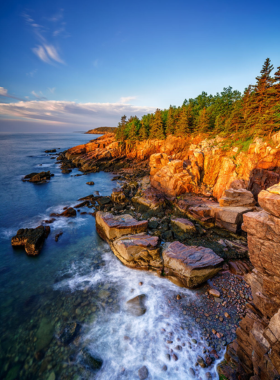 This image shows the breathtaking views of Acadia National Park, highlighting its diverse landscapes including lush forests, rocky shorelines, and the picturesque Cadillac Mountain. A perfect place for outdoor adventures.