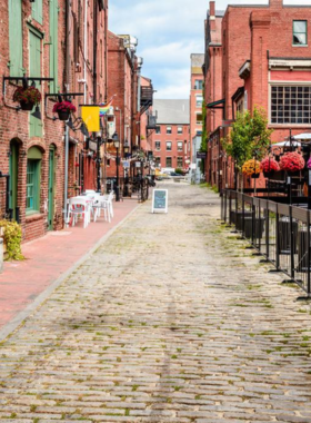  This image shows the charming Old Port district of Portland, Maine, with its cobblestone streets, historic buildings, and lively harbor, offering a mix of shopping, dining, and waterfront views.