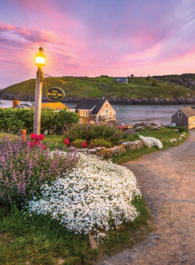 This image shows the rugged cliffs of Monhegan Island, Maine, offering spectacular ocean views and an idyllic, quiet retreat surrounded by nature, perfect for hiking and relaxation.