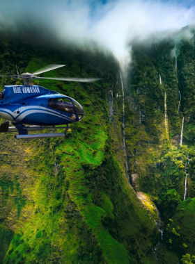 This image shows an aerial view of Maui’s stunning landscapes taken during a helicopter tour. The lush valleys, towering waterfalls, and expansive coastline are captured from above, providing a unique perspective of the island’s beauty.

