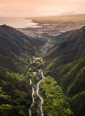 This image shows the iconic 'Iao Needle in the Iao Valley State Monument. Surrounded by lush greenery, the needle rises sharply above the valley floor, offering a dramatic view of one of Maui’s most significant cultural and natural landmarks.