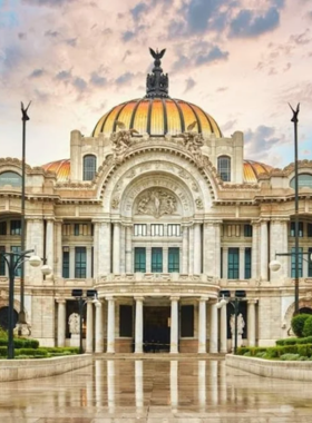 This image shows the stunning Palacio de Bellas Artes, a white-marble building with an orange domed roof. It highlights the fusion of Art Nouveau and Art Deco styles, surrounded by tourists admiring its beauty in the heart of Mexico City.