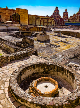 This image shows the ruins of Templo Mayor, once the sacred Aztec temple, with stone foundations and artifacts displayed in an open-air setting. It offers a glimpse into ancient Tenochtitlán, surrounded by modern cityscapes.