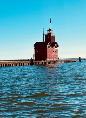 This image shows the sandy beaches of Holland State Park with the iconic Big Red Lighthouse in the background, offering visitors a relaxing escape along Lake Michigan’s shores.