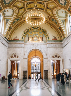 This image shows the iconic front entrance of the Detroit Institute of Arts, with visitors walking toward the grand building, offering a glimpse into the city’s rich cultural and artistic heritage.