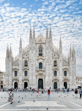 This image shows Milan Cathedral, an iconic Gothic church in Piazza del Duomo, with its intricate marble statues, spires, and stunning stained-glass windows. The rooftop offers panoramic city views, making it a must-visit for Milan's visitors.