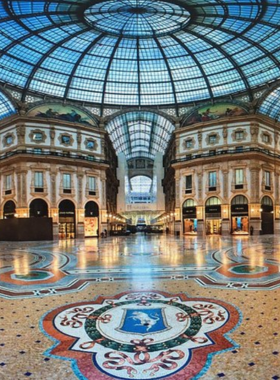 This image shows the Galleria Vittorio Emanuele II, a 19th-century shopping gallery with a glass dome, detailed mosaics, and high-end boutiques. It’s a blend of historic architecture and luxury, offering a unique Milanese experience.