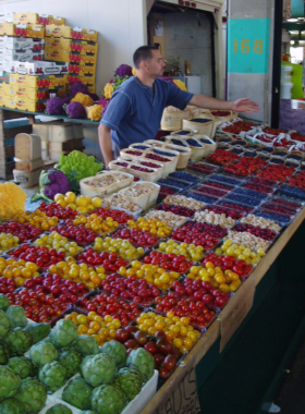 This image shows the bustling Jean-Talon Market, with vibrant fruit and vegetable stalls, local artisans, and fresh Quebecois products that define Montreal’s food culture.