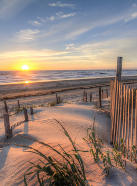 This image shows the serene, untouched beaches of the Outer Banks, ideal for a quiet escape, with beautiful coastal views and minimal commercial development.