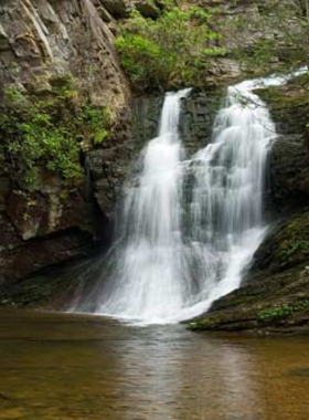 This image shows the panoramic view from Hanging Rock in North Carolina’s Hanging Rock State Park, where visitors can hike and enjoy breathtaking mountain scenery.