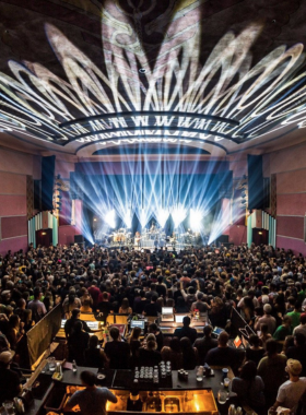 "This image shows a live concert at the Boulder Theater, with the stage illuminated and the audience enjoying the performance. The theater’s vintage charm, intimate setting, and excellent acoustics create a unique experience for music lovers and performers alike."