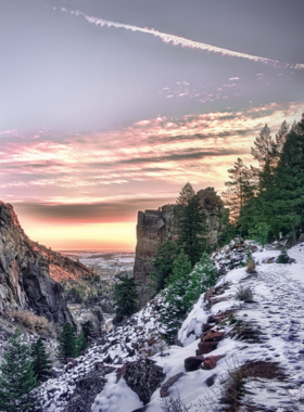 "This image shows hikers on the Rattlesnake Gulch Trail in Eldorado Canyon State Park, with panoramic views of the surrounding landscapes and the historic ruins of the Crags Hotel. The trail’s moderate difficulty offers scenic beauty and a glimpse into Boulder’s past."