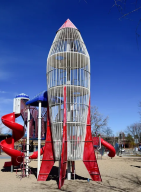 "This image shows Scott Carpenter Park, with families enjoying the playground, swimming pools, and open green spaces. The park's friendly atmosphere and recreational facilities make it an ideal spot for picnics, casual sports, and relaxation, offering fun for all ages."