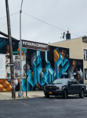 This image shows that the Bushwick Collective is an open-air street art gallery in Brooklyn, featuring colorful murals by local and international artists, offering a vibrant and creative urban experience.